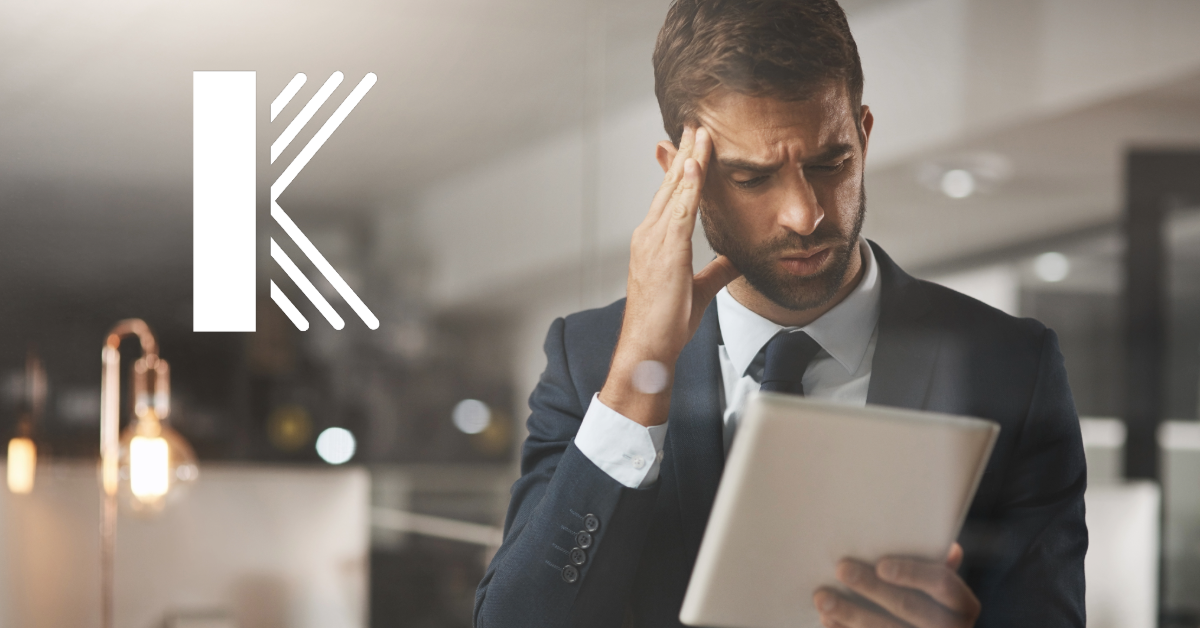 Stressed accountant reviewing a tablet, highlighting the need for Errors and Omissions Insurance to protect against financial risks