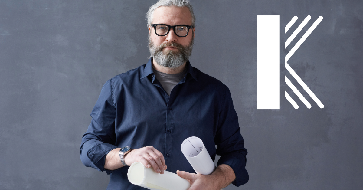 gray haired and bearded architect holding blueprints with Kastner Insurance logo adjacent