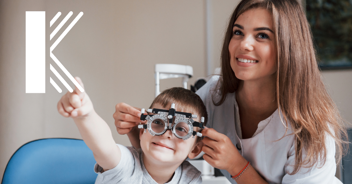 A female optometrist helping a young patient with an eye exam