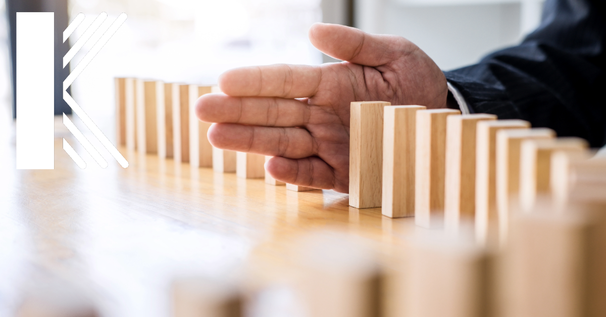 interruption in the process depicted by hand and dominoes with Kastner Insurance logo featured